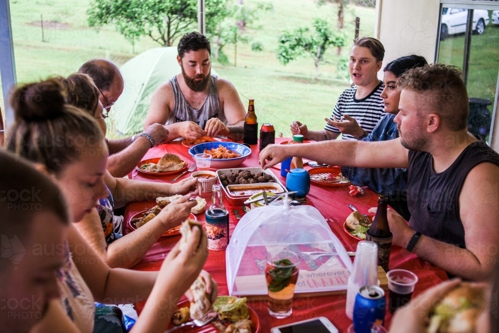 Family share conversation and chistmas lunch together outside on a summers day. - Australian Stock Image