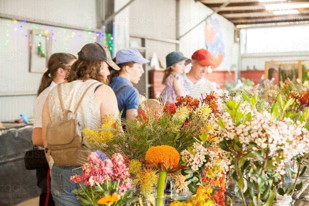Family walking through pavilion looking at flower entries at local show - Australian Stock Image
