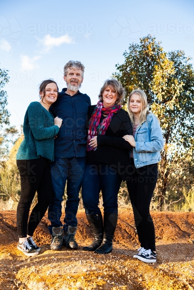 Family with teenage daughters together in australian landscape - Australian Stock Image