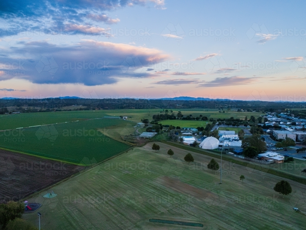 Farm paddock by park and Gym and swim in singleton on overcast evening - Australian Stock Image