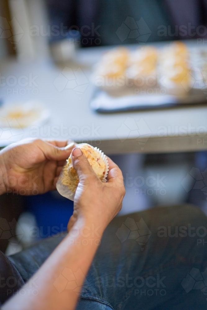 Farm worker having a muffin for smoko - Australian Stock Image