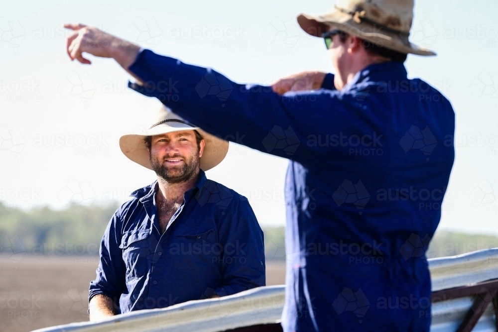 Farmers talk near stockyards during the drought - Australian Stock Image
