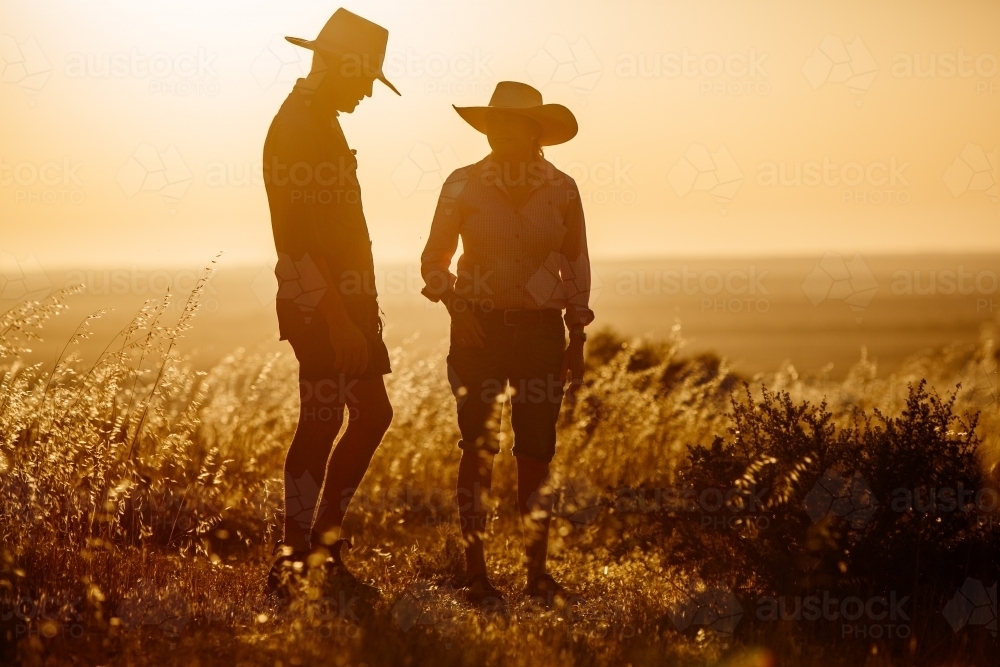 Farming couple wearing hats on their rural property - Australian Stock Image
