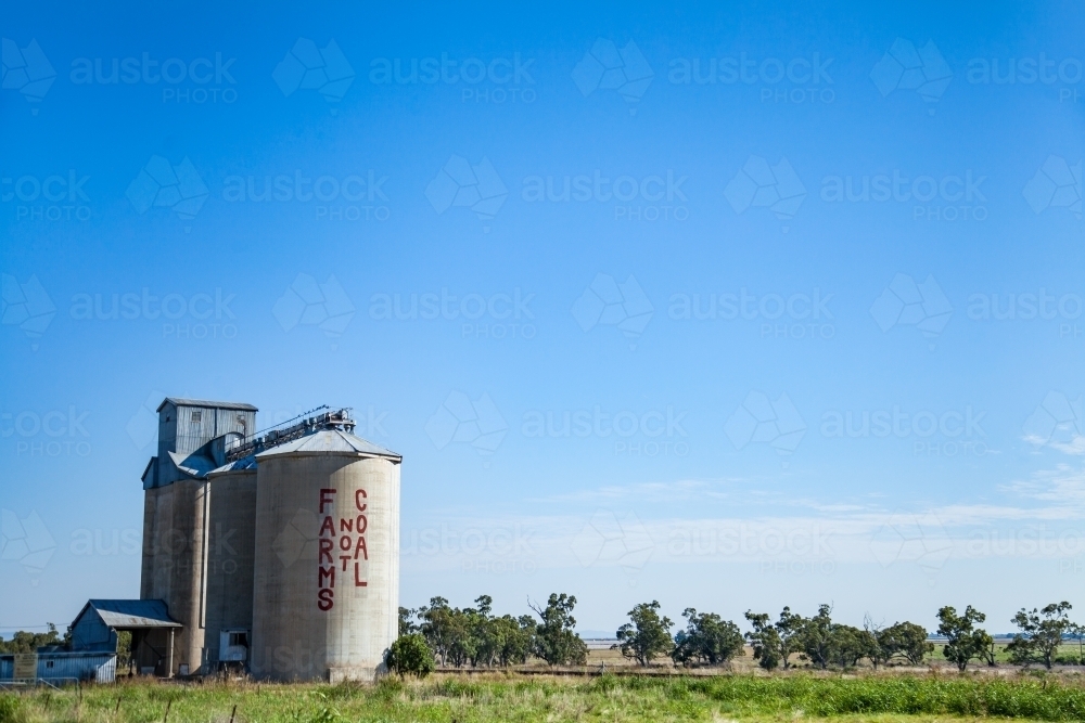 Farms not coal written on silo in country town - Australian Stock Image