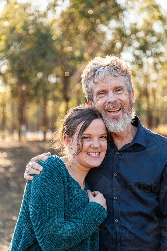 Father and adult daughter hug - Australian Stock Image