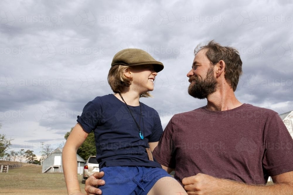 Father and daughter on the farm looking at each other - Australian Stock Image