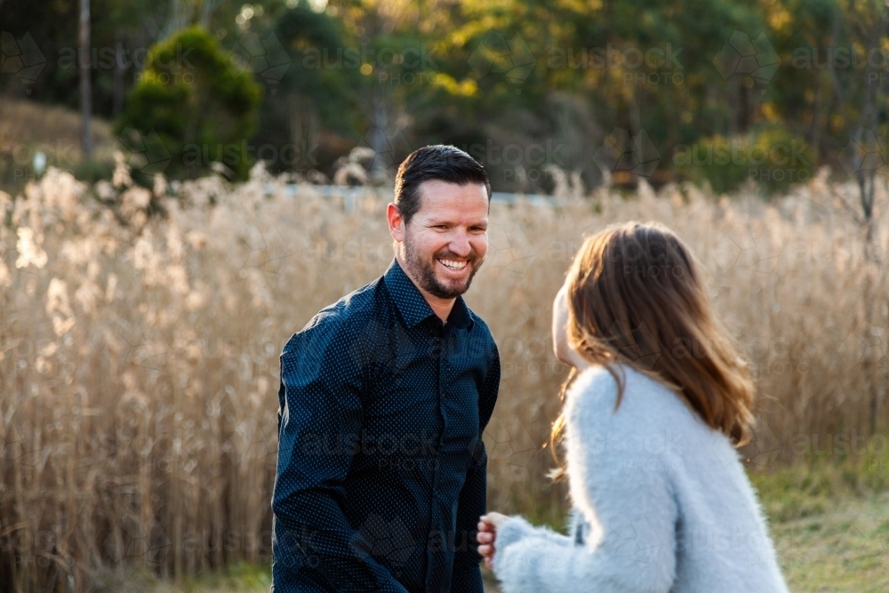 Father and daughter playing tips outside - Australian Stock Image