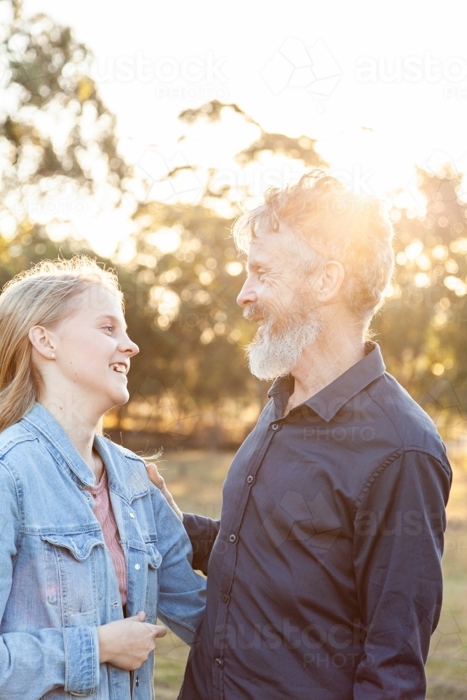 Father and daughter together in golden afternoon light - Australian Stock Image