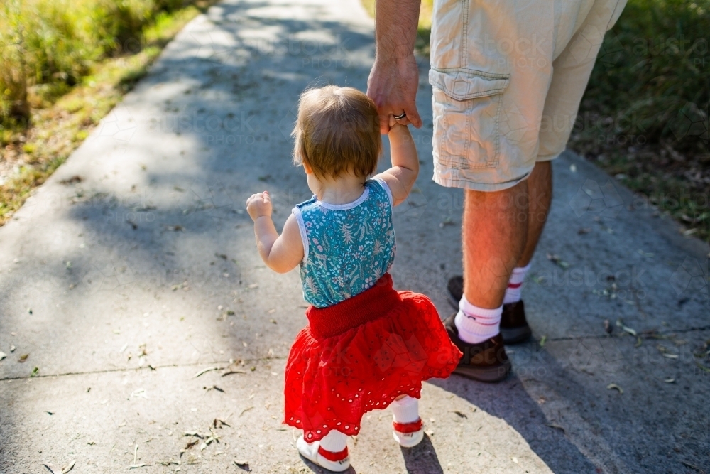 Image of Father and daughter walking along path - toddler with red ...