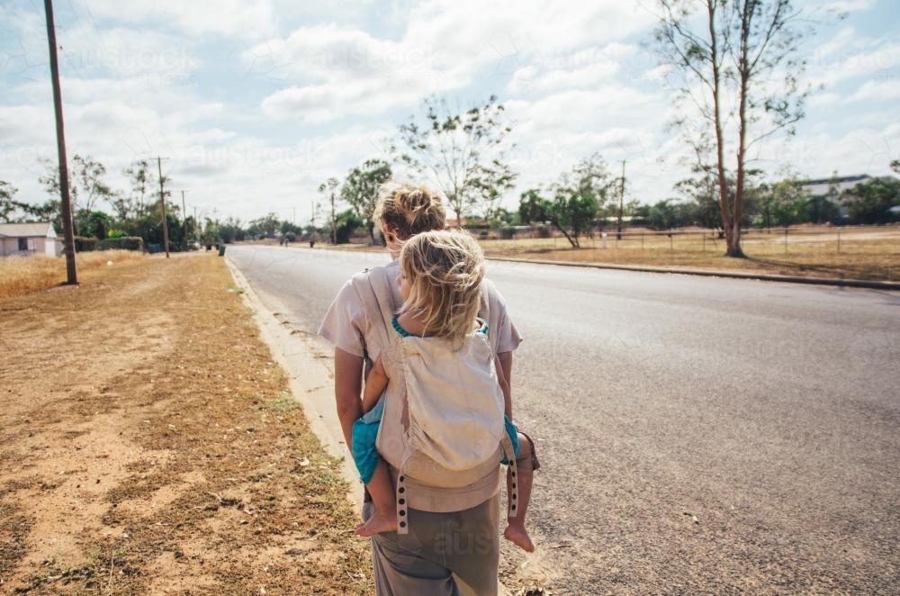 Father and daughter walking on rural streets - Australian Stock Image