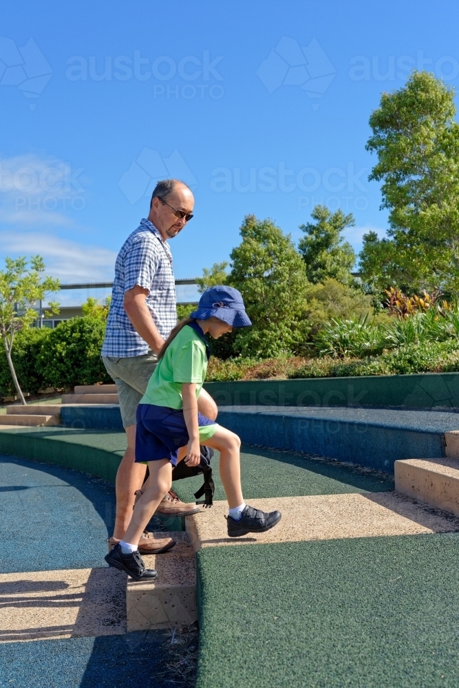 Father and daughter walking to school and class room attending an Australian School - Australian Stock Image
