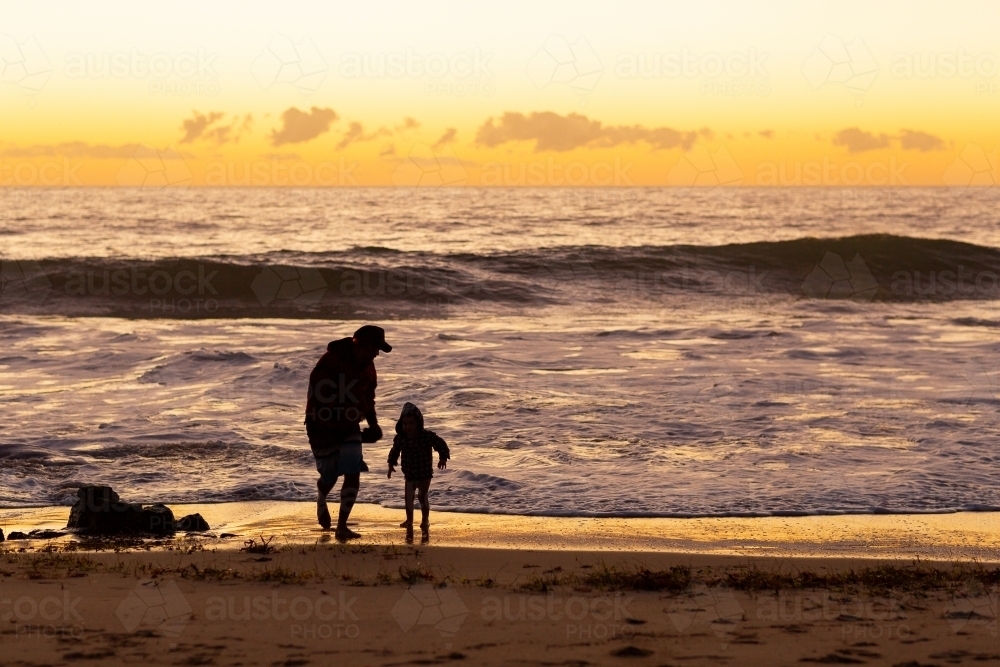 Father and son at the seashore at sunset - Australian Stock Image