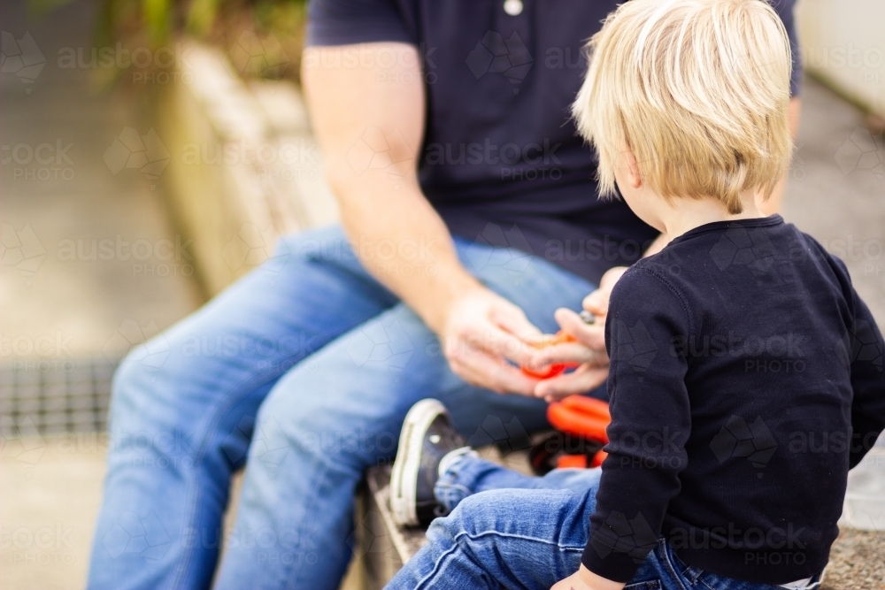 Father and son playing with toy tools - Australian Stock Image