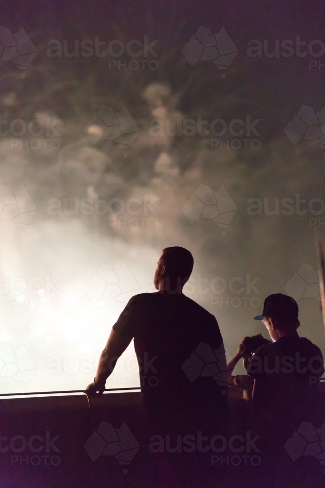 Father and son watching the fireworks display at skyfire, Canberra - Australian Stock Image