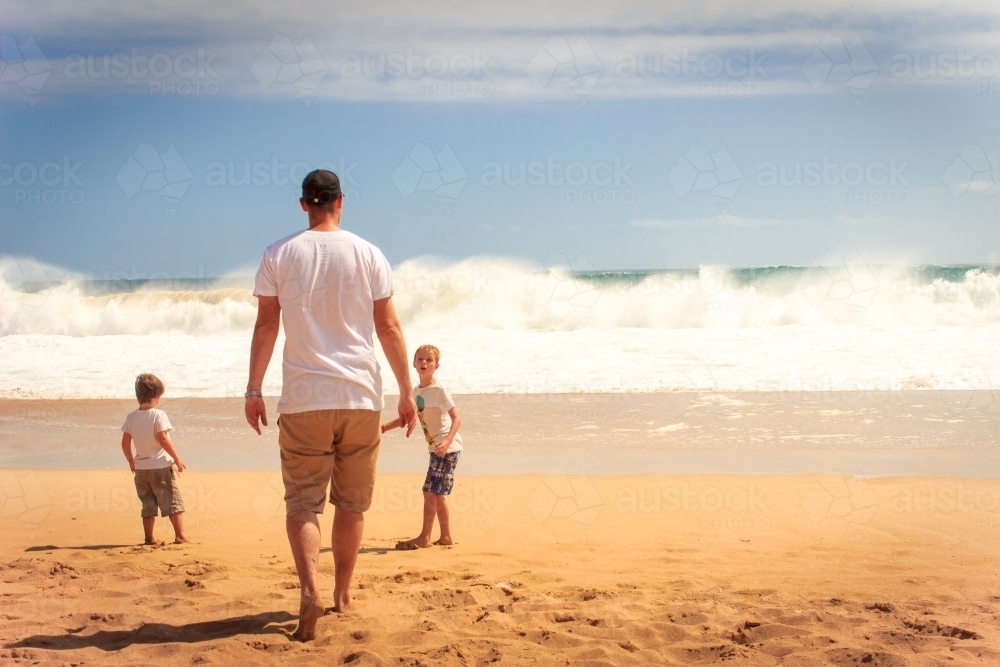 Father and sons at the beach - Australian Stock Image