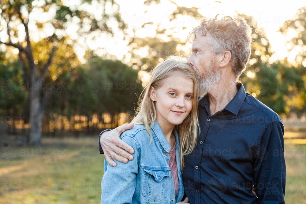 Father kisses daughter on her head - Australian Stock Image
