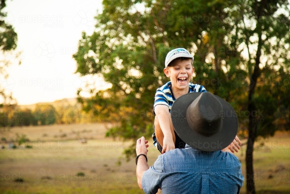 Father ready to catch laughing son - Australian Stock Image
