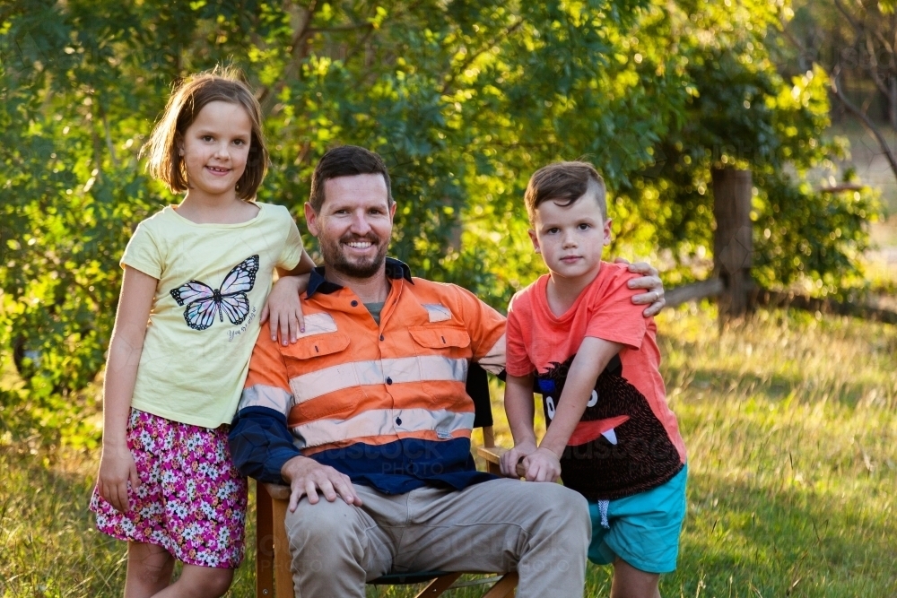 Father relaxing after work with his daughter and son - Australian Stock Image