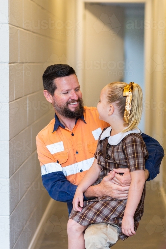 Father saying goodbye to daughter before school and work - Australian Stock Image