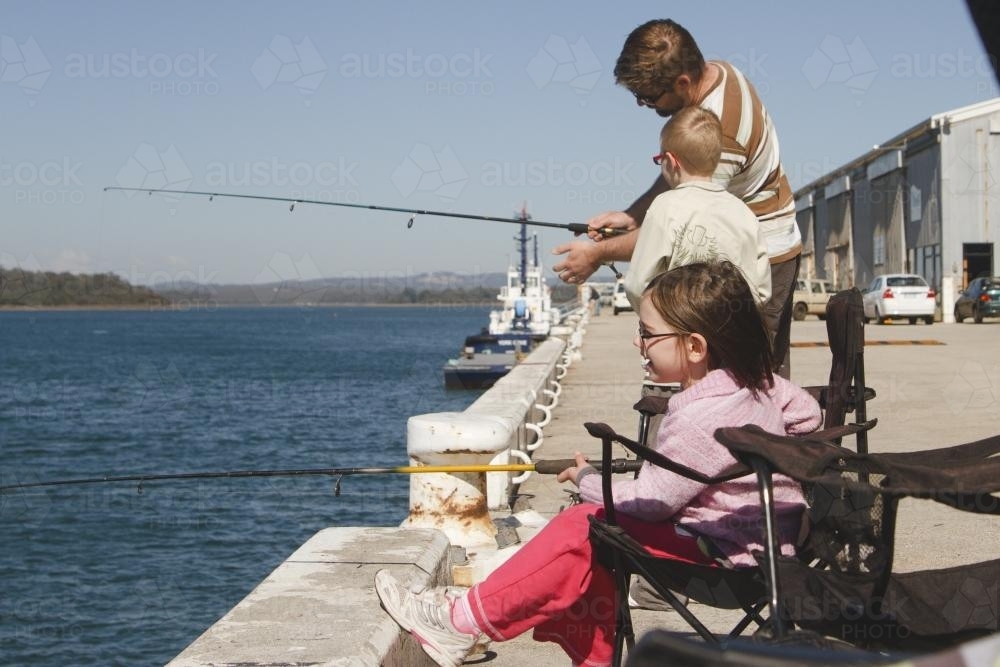 Father, Son and Daughter Fishing off wharf - Australian Stock Image