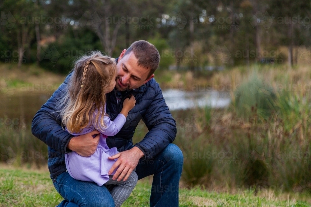 Father talking with his young daughter outside - Australian Stock Image