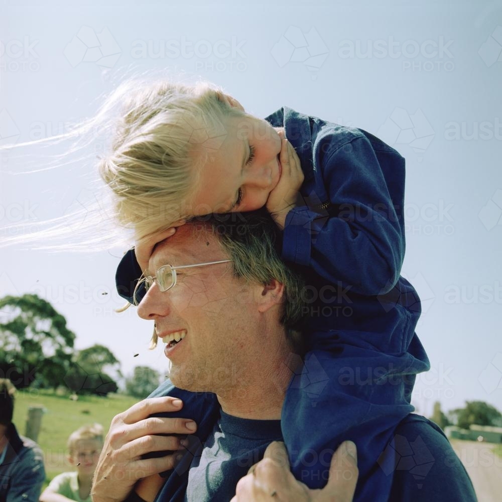 Father with daughter on shoulders on the farm - Australian Stock Image