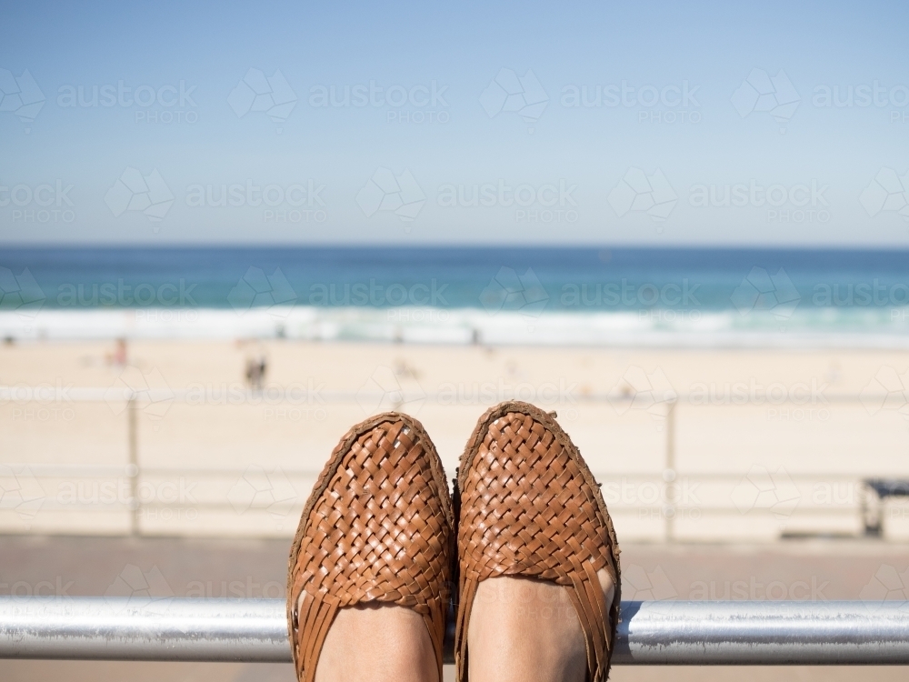 Feet resting whilst looking at the beach - Australian Stock Image