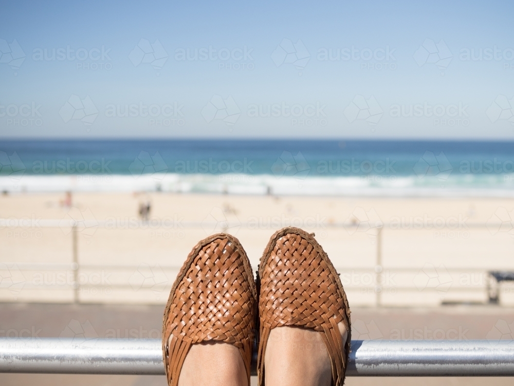 Feet resting whilst looking at the beach - Australian Stock Image
