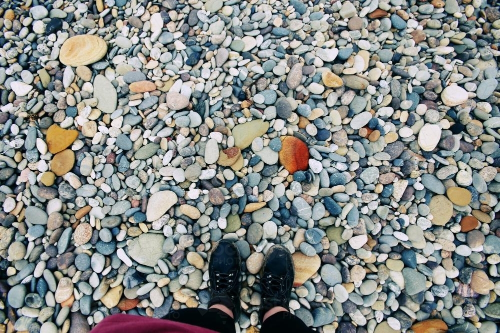 Image of Feet standing on rocks - Austockphoto