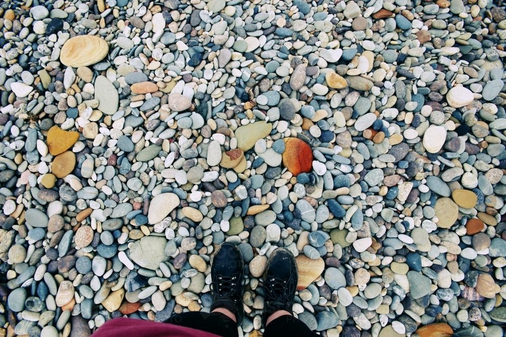 Feet standing on rocks - Australian Stock Image