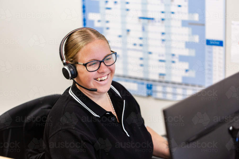 Image of female administrate staff lady sitting by computer at front ...
