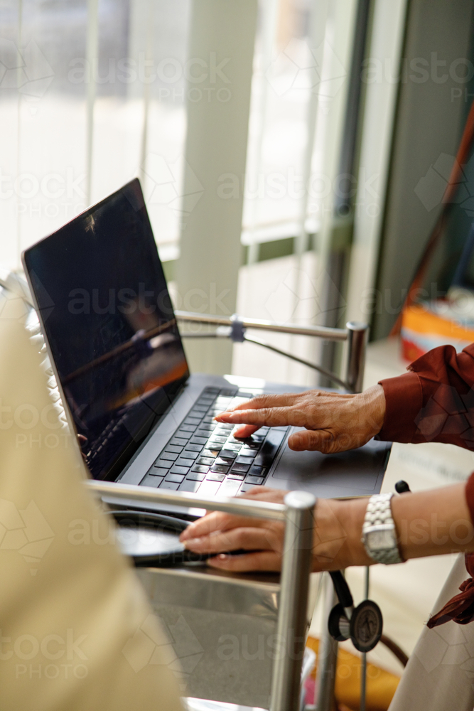Female doctor typing on the laptop for documentation - Australian Stock Image