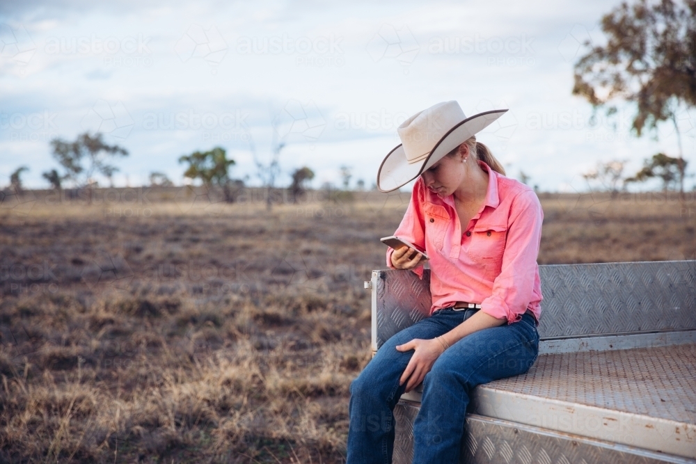 Female farmer holding iPhone - Australian Stock Image