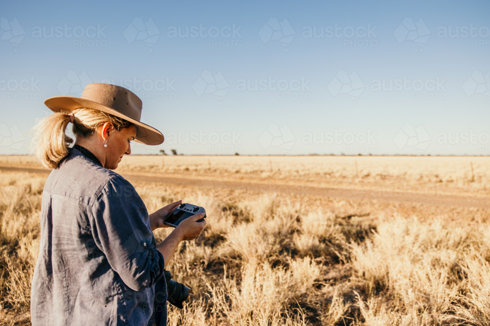 Female flying drone in rural Australia - Australian Stock Image