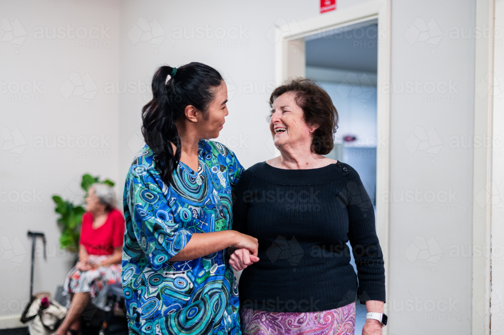 Image of Female healthcare worker assisting an elderly woman walk ...
