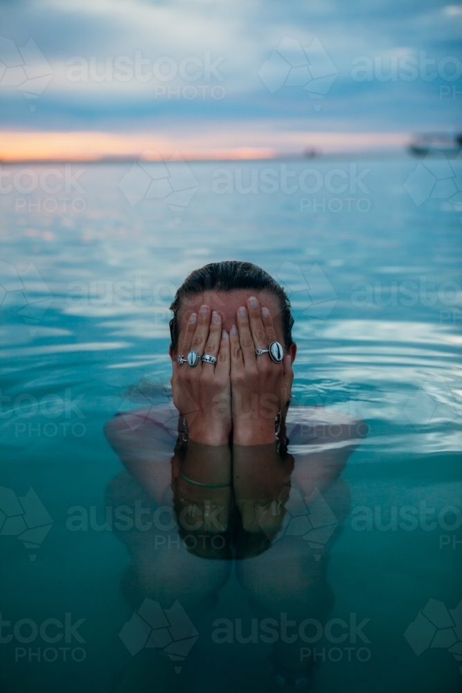 Female in ocean at sunset - Australian Stock Image