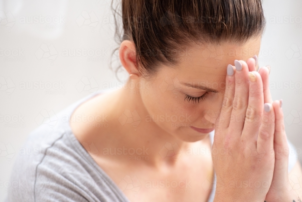 female meditating hands to third eye - Australian Stock Image