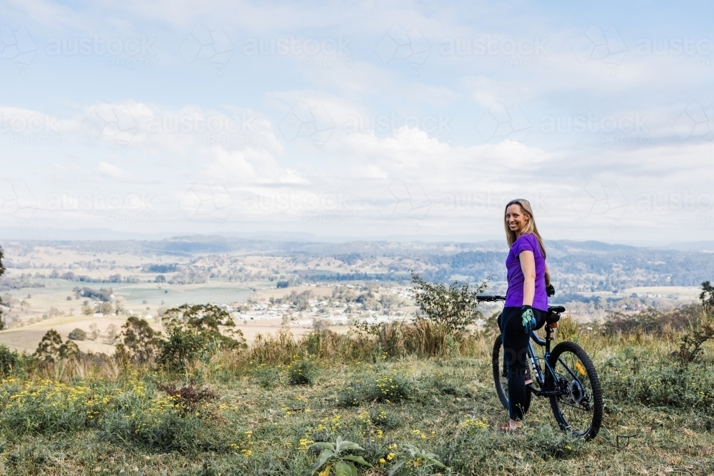 female mountain biker on top of the hill - Australian Stock Image