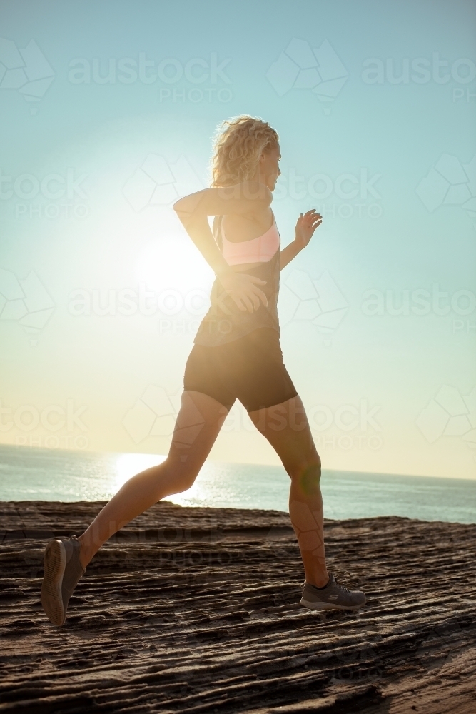Female runner Morning Cliffside - Australian Stock Image