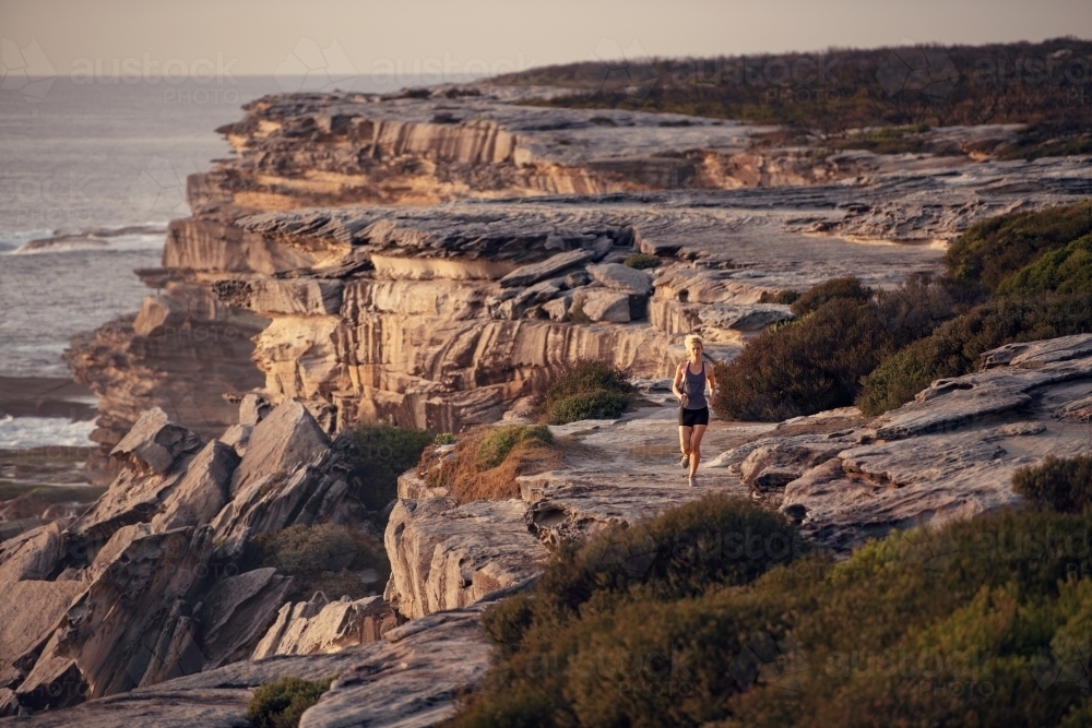 Female runner Morning Cliffside - Australian Stock Image