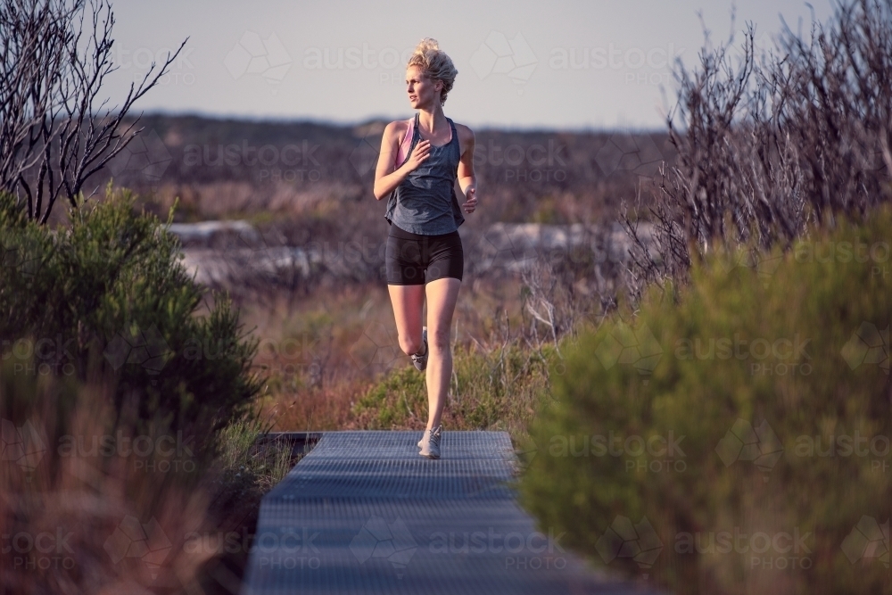 Female runner Morning Cliffside - Australian Stock Image