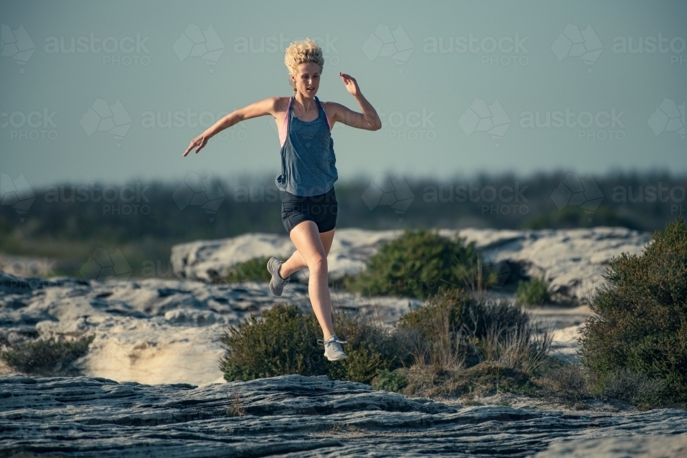 Female runner Morning Cliffside - Australian Stock Image