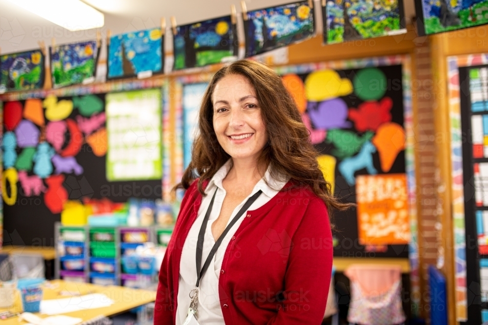 Female Teacher Smiling in a School Classroom - Australian Stock Image