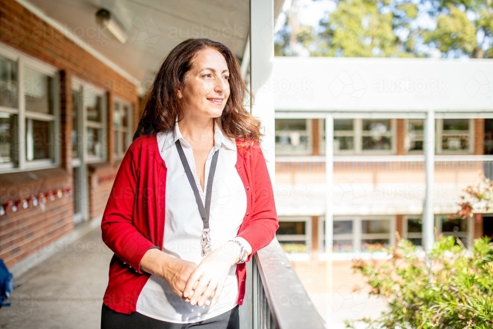 Female Teacher Standing on a School Balcony - Australian Stock Image