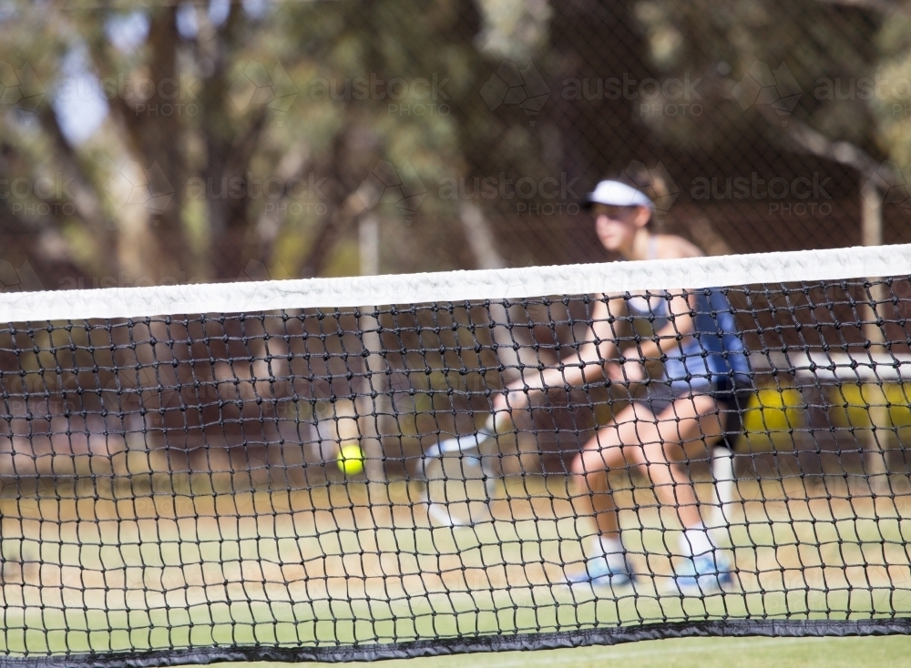 Female tennis player hitting ball - Australian Stock Image