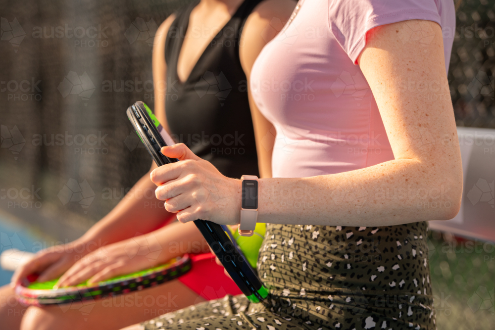 Image of female tennis player with wearable fitness tracker and tennis ...