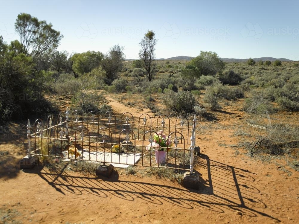 Fenced grave in the outback on a sunny day - Australian Stock Image