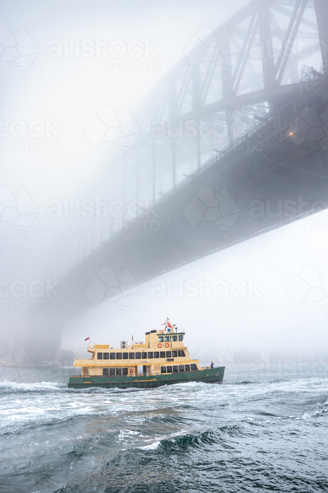 Ferry and fog under harbour bridge - Australian Stock Image