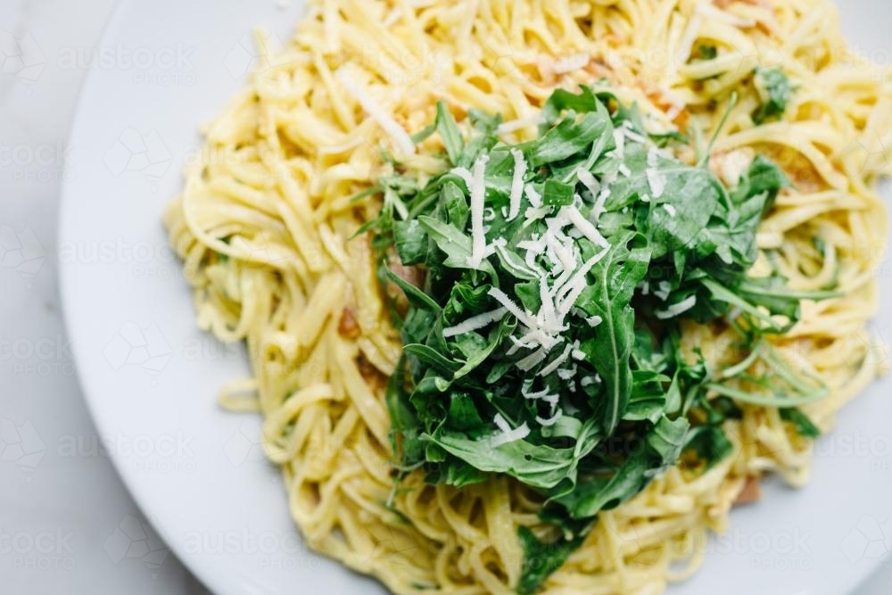 fettuccine carbonara pasta with rocket and parmesan - Australian Stock Image
