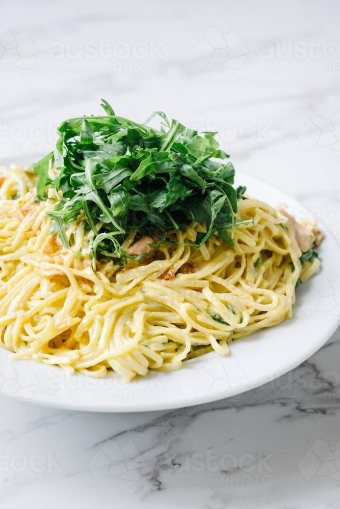 fettuccine carbonara pasta with rocket and parmesan - Australian Stock Image